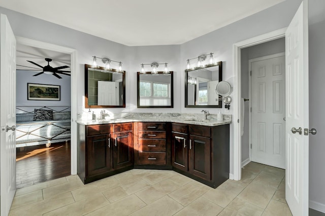 bathroom with double vanity, a sink, a ceiling fan, and tile patterned floors