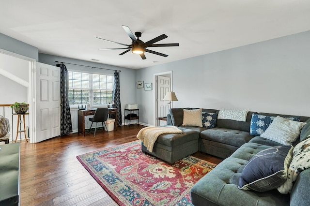 living area featuring wood finished floors, a ceiling fan, and baseboards