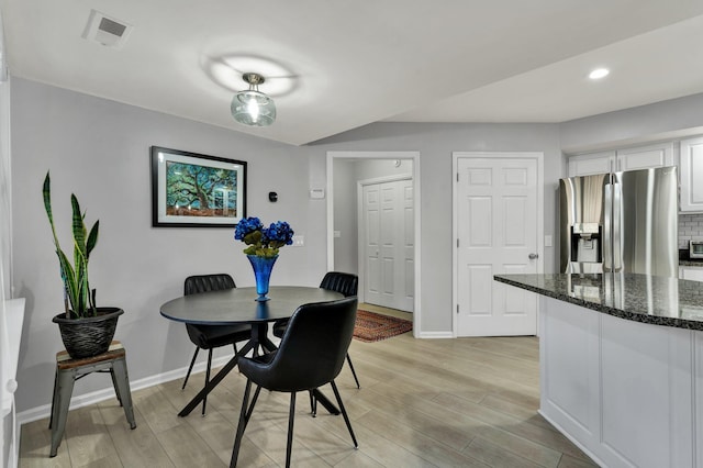 dining space featuring light wood finished floors, baseboards, visible vents, and recessed lighting