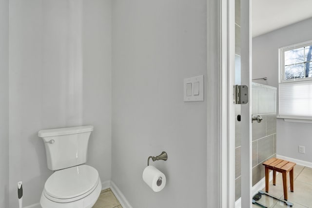 bathroom featuring baseboards, toilet, and tile patterned floors