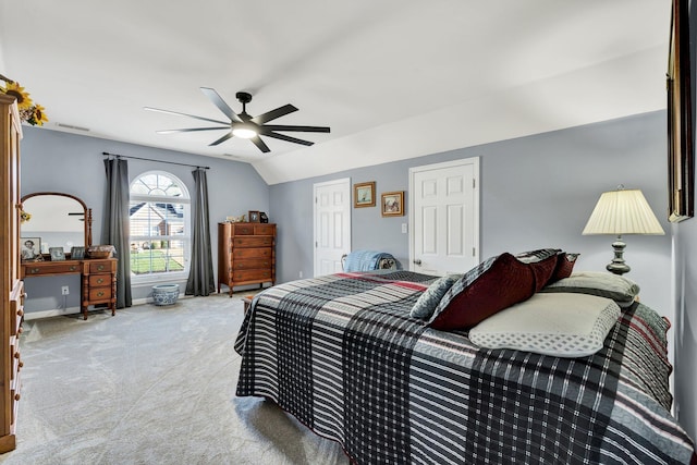 carpeted bedroom featuring lofted ceiling, ceiling fan, and baseboards