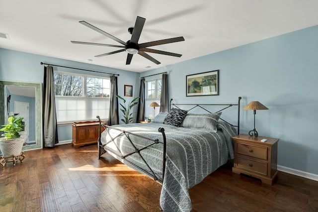 bedroom with a ceiling fan, dark wood finished floors, visible vents, and baseboards