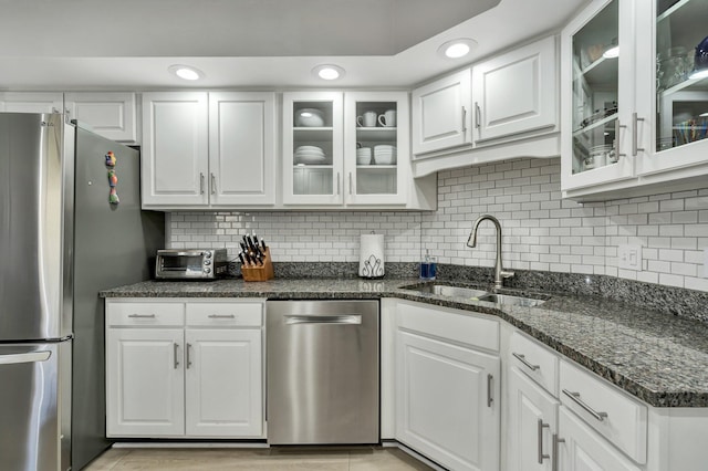 kitchen featuring stainless steel appliances, white cabinetry, and a sink