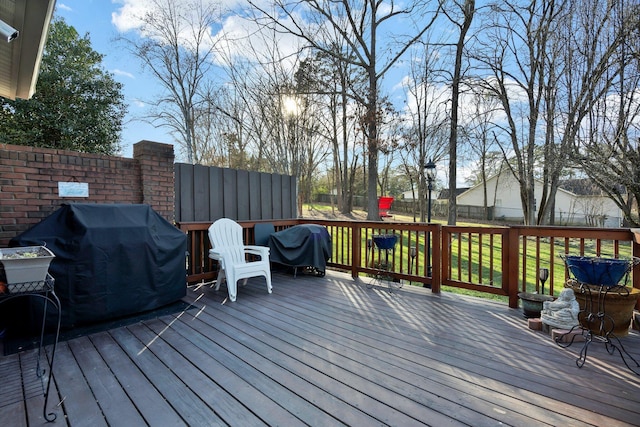 wooden deck featuring fence and grilling area