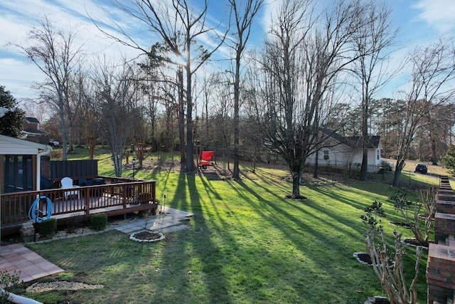 view of yard featuring fence and a deck