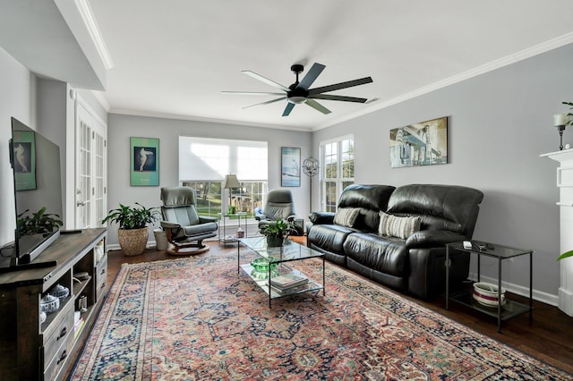 living area featuring a ceiling fan, baseboards, ornamental molding, and wood finished floors