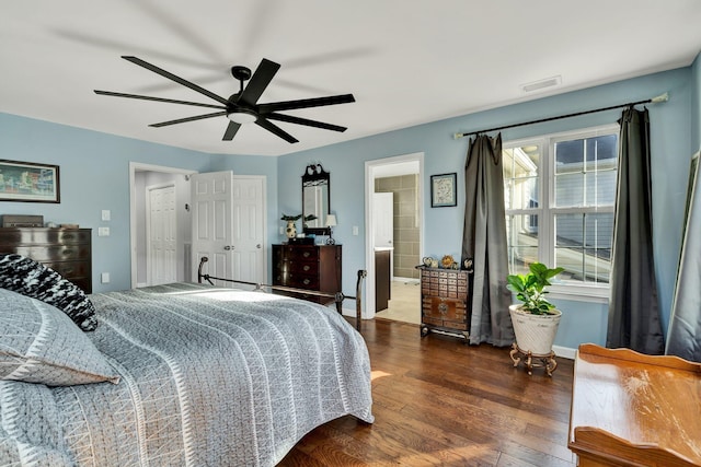 bedroom featuring baseboards, visible vents, dark wood-style floors, ceiling fan, and ensuite bathroom