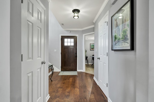 entrance foyer with dark wood-style floors, ornamental molding, and baseboards