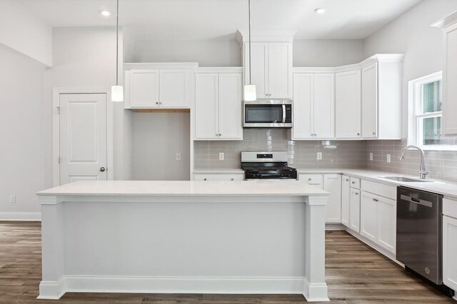 kitchen featuring stainless steel appliances, white cabinets, and a sink