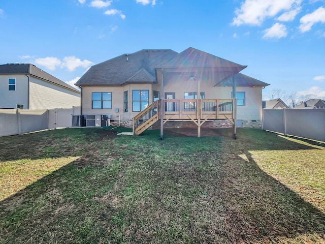 rear view of property with crawl space, a fenced backyard, a yard, and stairway