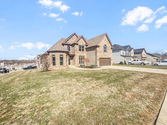 french country inspired facade with driveway, a garage, stone siding, a front yard, and brick siding