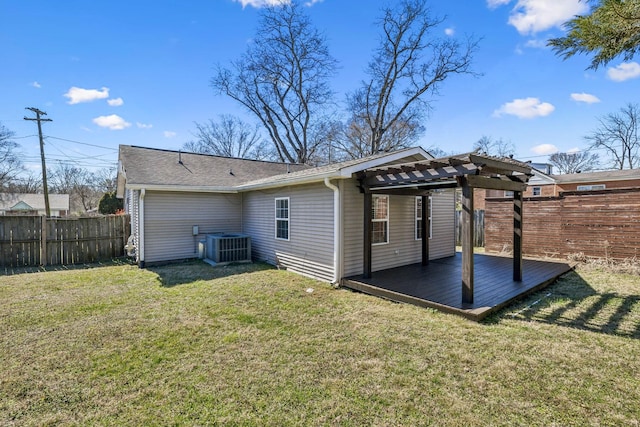 rear view of house with a deck, central AC unit, fence, a lawn, and a pergola