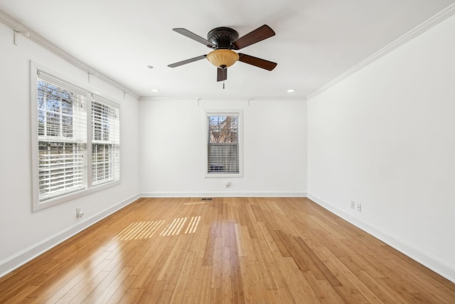 unfurnished room with light wood-type flooring, baseboards, ornamental molding, and a ceiling fan