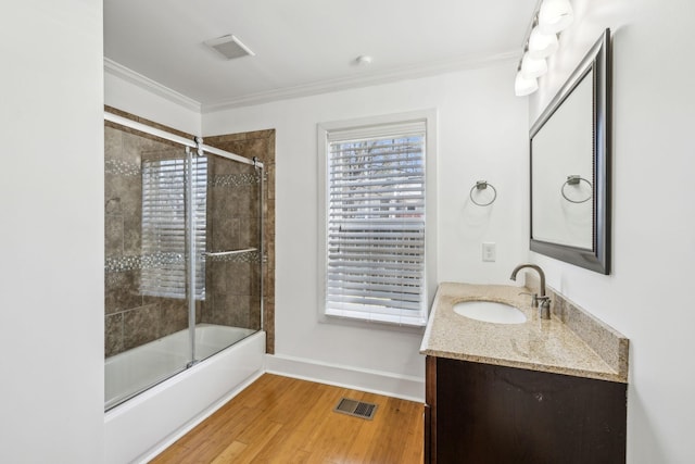 full bathroom with vanity, visible vents, crown molding, and wood finished floors