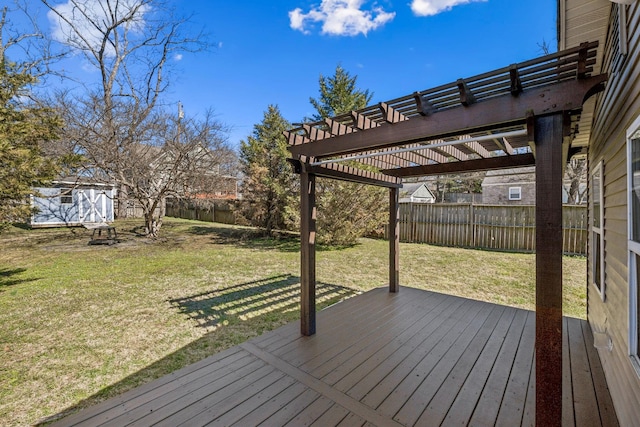 deck with a lawn, an outdoor structure, a fenced backyard, and a pergola