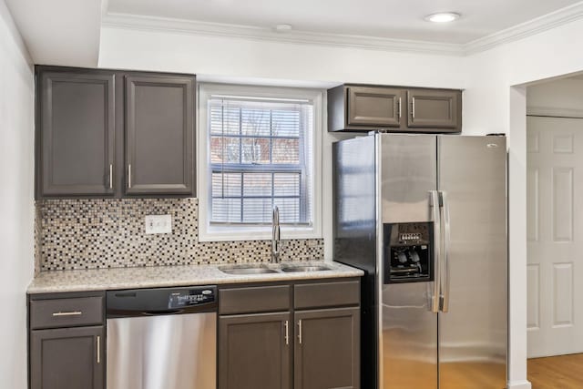 kitchen with tasteful backsplash, ornamental molding, wood finished floors, stainless steel appliances, and a sink