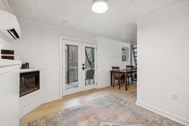 entryway featuring an AC wall unit, french doors, wood finished floors, and wood ceiling