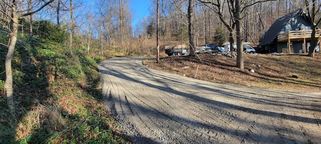 view of street featuring a forest view