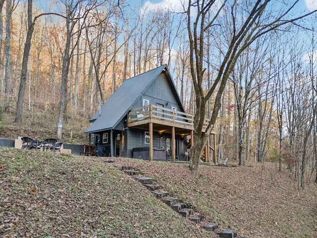 chalet / cabin featuring metal roof and a wooden deck