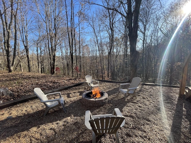 view of yard featuring an outdoor fire pit