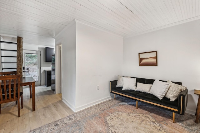 living area with wooden ceiling, light wood-style floors, baseboards, and crown molding