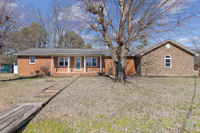 ranch-style house with stone siding, brick siding, crawl space, and a front lawn