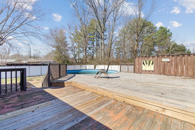 deck featuring a fenced in pool and fence