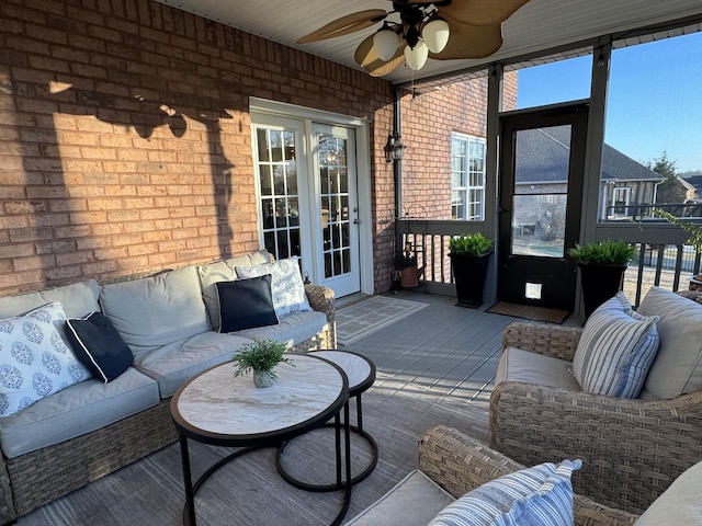 sunroom featuring ceiling fan