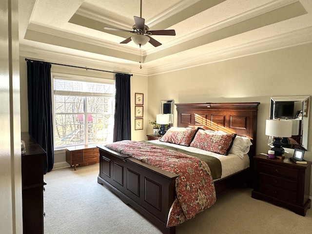 bedroom featuring a raised ceiling, light carpet, and ornamental molding