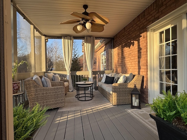 wooden deck with an outdoor living space and ceiling fan