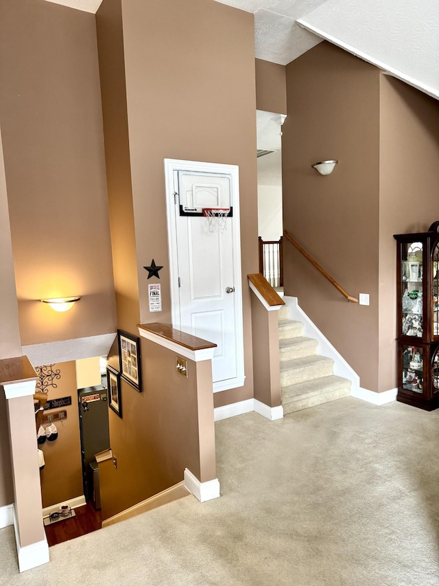 staircase with carpet flooring and baseboards