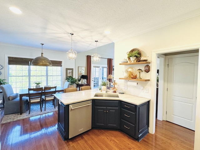 kitchen featuring a sink, open shelves, dishwasher, light countertops, and dark wood-style flooring