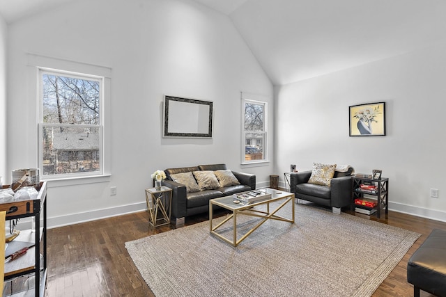 living room with high vaulted ceiling, baseboards, and wood finished floors