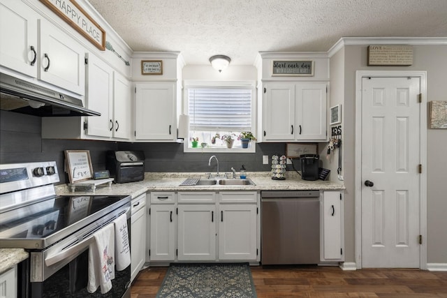 kitchen featuring white cabinets, dark wood-style floors, stainless steel appliances, under cabinet range hood, and a sink