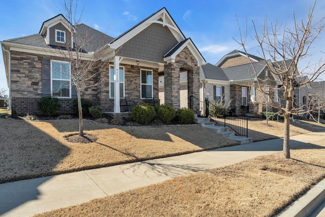 craftsman-style house featuring stone siding