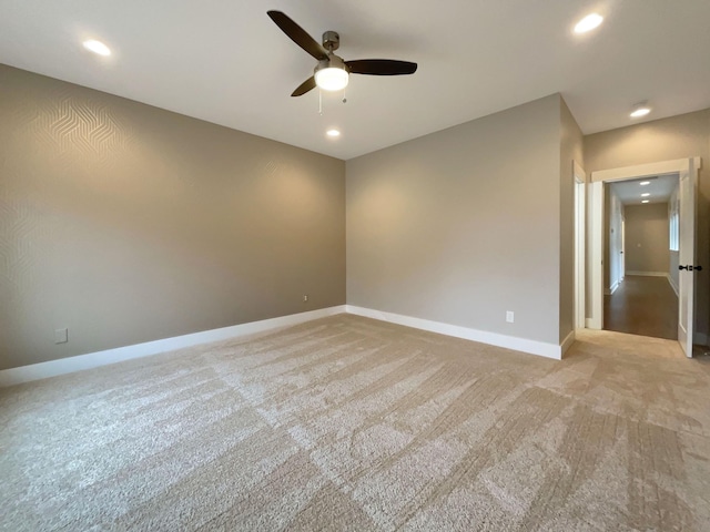 empty room featuring baseboards, light colored carpet, a ceiling fan, and recessed lighting