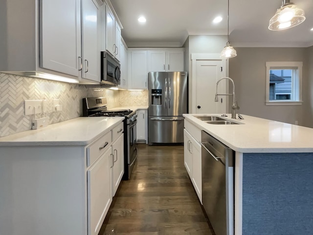 kitchen featuring decorative light fixtures, a sink, stainless steel appliances, white cabinetry, and backsplash