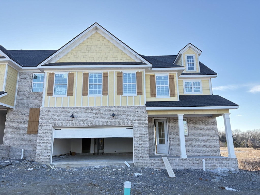 view of front facade with an attached garage and brick siding