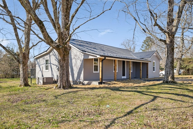 view of front facade with metal roof and a front yard