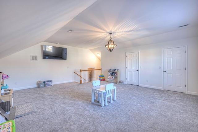 game room featuring vaulted ceiling, carpet flooring, visible vents, and a notable chandelier