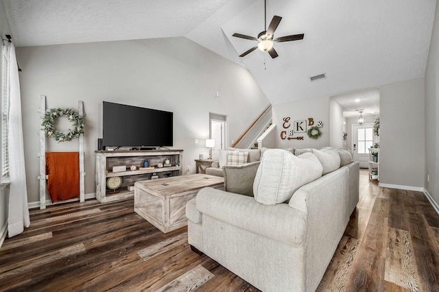 living area with dark wood-type flooring, visible vents, ceiling fan, and baseboards