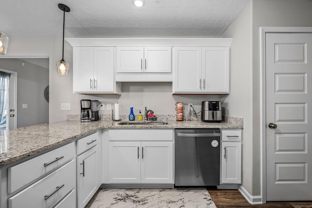 kitchen featuring a textured ceiling, a sink, white cabinets, hanging light fixtures, and dishwasher