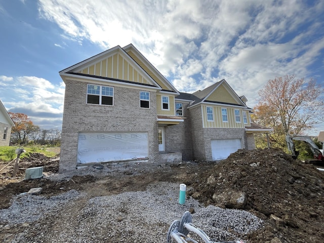 craftsman-style home with board and batten siding, brick siding, and a garage