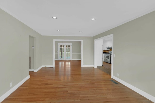 empty room with light wood-style floors, recessed lighting, french doors, and baseboards