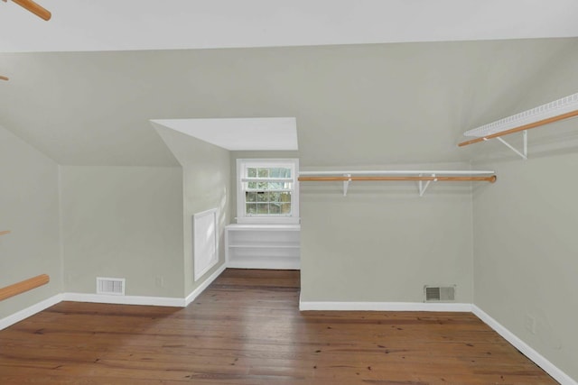 walk in closet featuring vaulted ceiling, wood-type flooring, and visible vents