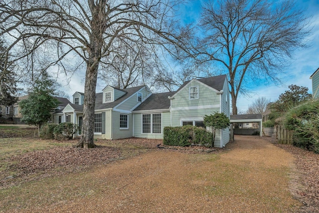 back of property featuring fence and a carport