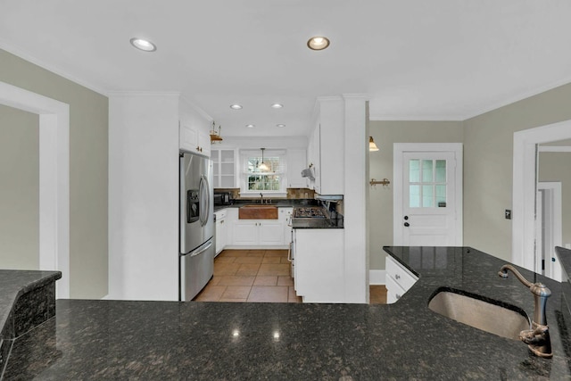 kitchen with white cabinetry, stainless steel appliances, a sink, and recessed lighting