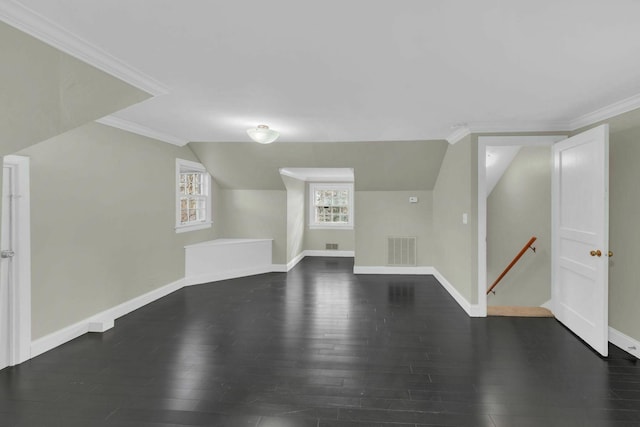 bonus room with lofted ceiling, visible vents, baseboards, and wood finished floors