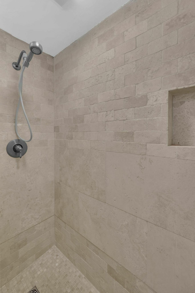 full bath with a tile shower