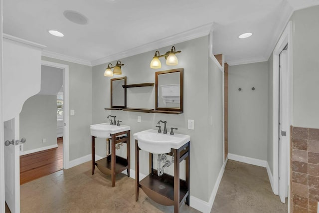 full bathroom with baseboards, two sinks, and crown molding